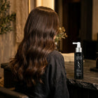 Thick shiny hair from behind beside the Roots & Ends spray